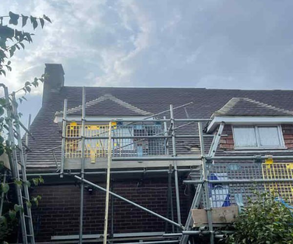 This is a photo of a roof with two dormers that is having some damaged tiles replaced. Works carried out by EFG Roofing Maltby